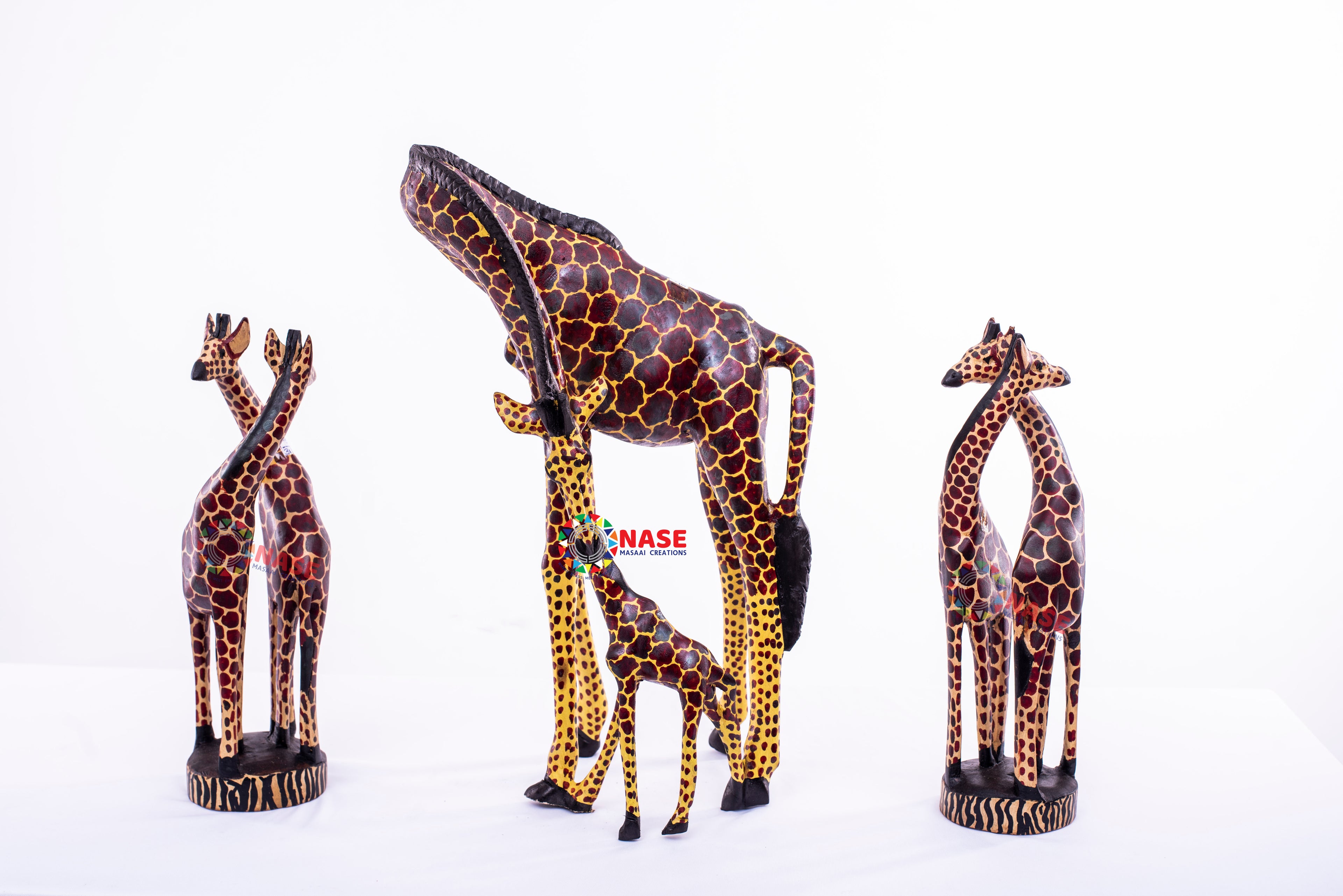 THREE SETS OF GIRAFFE CARVINGS