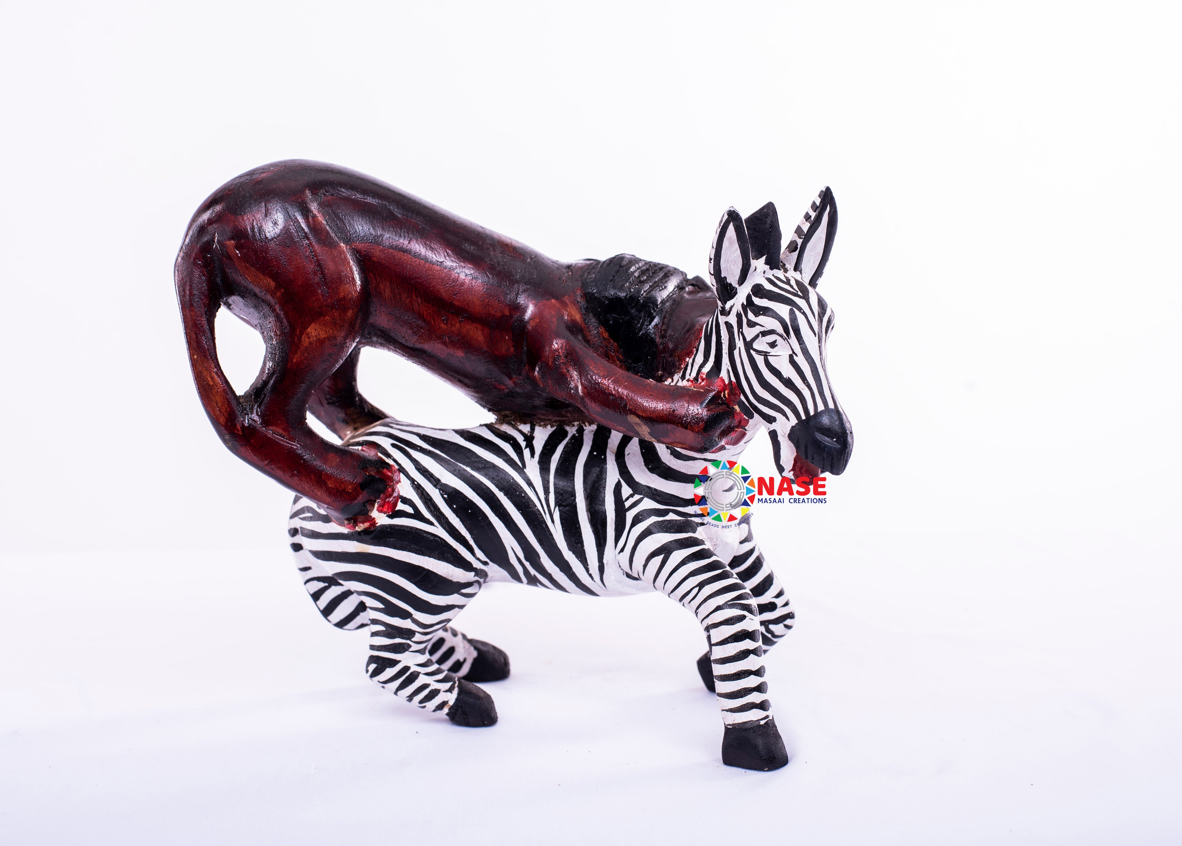LION ATTACKING ZEBRA WOODEN CARVINGS