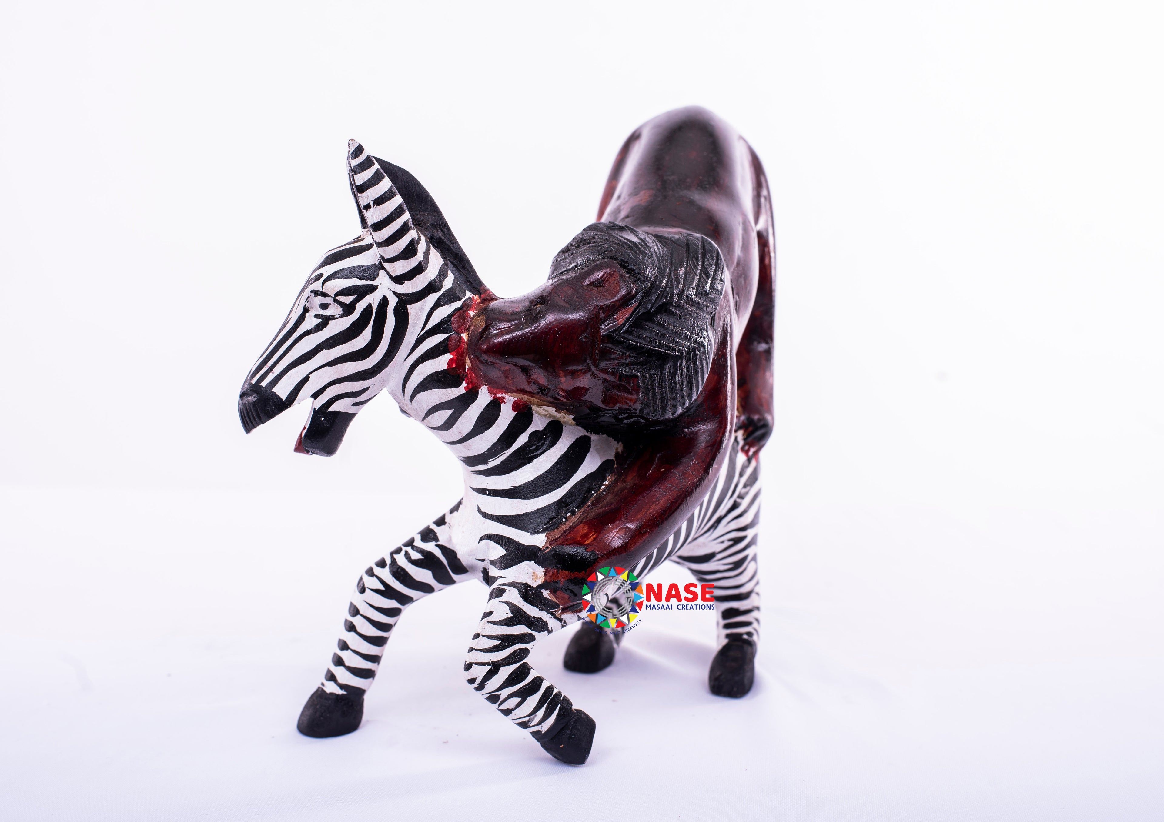 LION ATTACKING ZEBRA WOODEN CARVINGS
